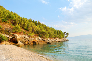 Sandy Beach and Green Hill with Blue Sea