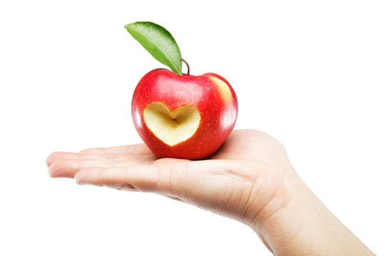 Woman's hand with an apple isolated on white background.