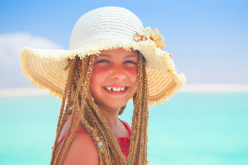 girl with straw hat smiling