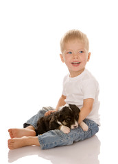 Fototapeta na wymiar Happy kid boy bonding his puppy dog isolated on white