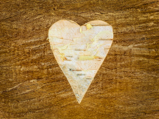 Wooden heart shape on a retro wooden background
