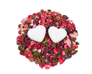 two gingerbread hearts in the background of sachet petals