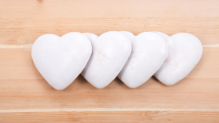four gingerbread hearts on wooden background