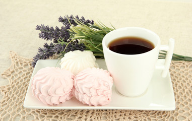 Marshmallows on plate on light background
