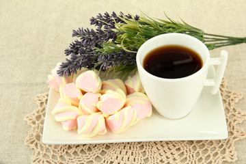 Marshmallows on plate on light background
