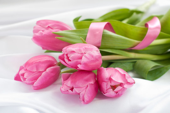 Pink tulips on white silk with ribbon