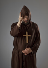 Monk in brown robe blessing
