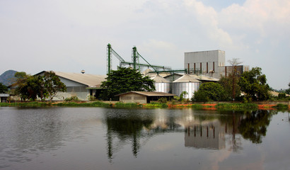 Naklejka premium industrial, silo near pond.