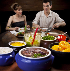 Feijoada - Brazilian meat & bean stew, side dishes & caipirinha