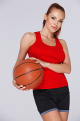 Attractive woman with a basketball