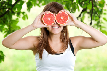 Young woman having fun with fruits