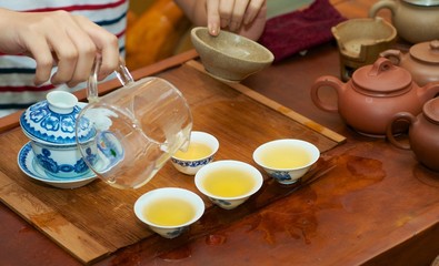 female hand take tea in tea ceremony