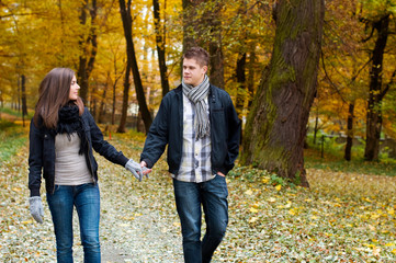 Young couple walking through the park