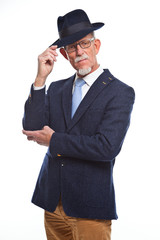 Serious well dressed senior man with hat. Isolated.
