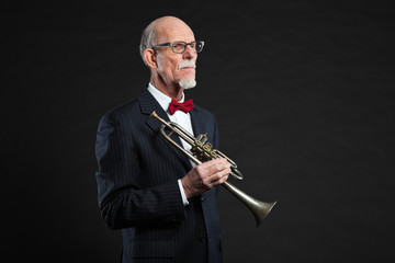 Senior jazz musician. Trumpet player. Studio shot.