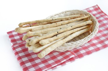 bread sticks with basket on red cloth