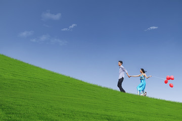 Beautiful landscape and couple on hill