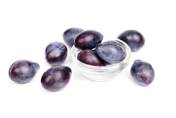 Some fresh blue plums on the white background