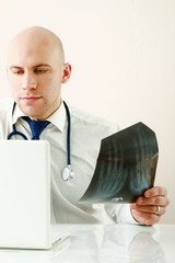 A male doctor studying a x-ray image