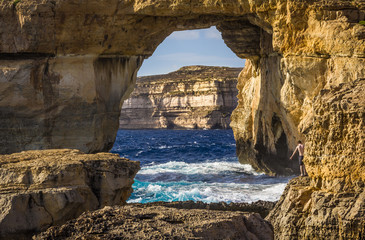 A boy scared of jumping at the Azure Window in Gozo