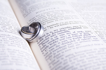 Two Hebrew wedding rings on an open Afrikaans Bible