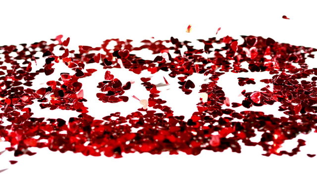 Confetti spelling out love blowing away