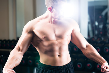 Bodybuilder posing in Gym