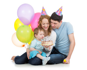 kid with parents celebrating birthday  and blowing candles on ca © Oksana Kuzmina