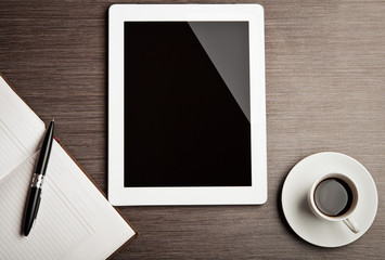 empty tablet and a coffee on the desk