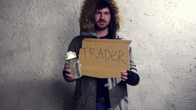 Homeless trader holding tin cup
