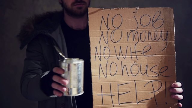 homeless hold out a tin and a cardboard 