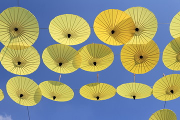Fototapeta na wymiar yellow umbrellas against a bright blue sky