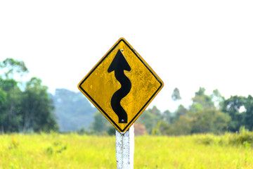 winding road sign in yellow