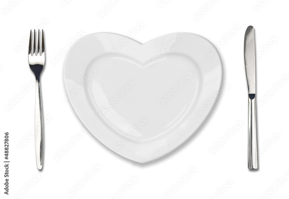 Poster plate in shape of heart, table knife and fork isolated on white