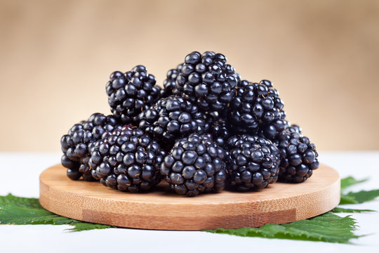 Blackberries on wooden plate