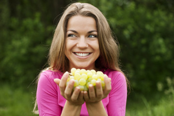 Young woman with grapes