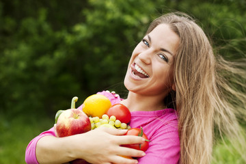 Young woman holding fruits and vegetables