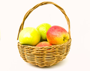 Green and red apples in a basket isolated on white background