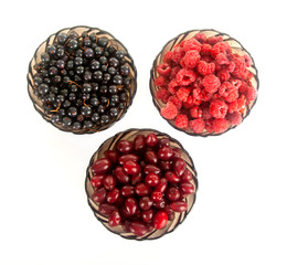 different fresh berries: raspberries, currant, dogwood berries