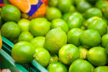 Bunch of limes in box in supermarket