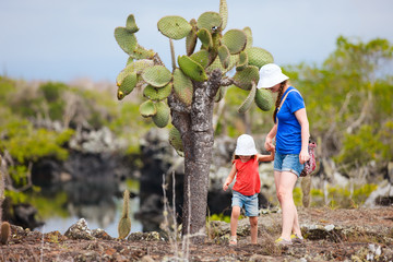 Mother and daughter walking at scenic terrain