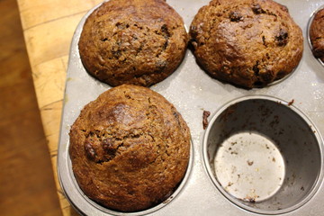 Freshly baked bran muffins cooling down in baking tin