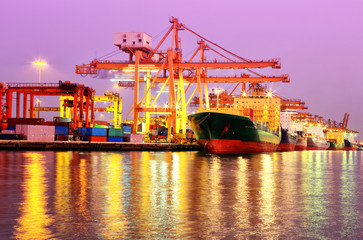 Container Cargo freight ship with working crane bridge in shipya
