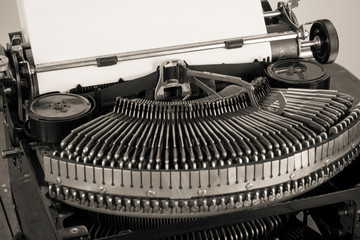 Vintage old typewriter and paper blank closeup desaturated photo