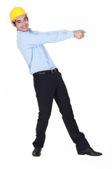 Smiling young engineer pulling an invisible rope