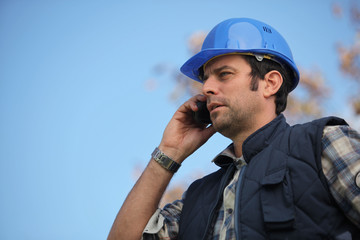 Foreman talking on his mobile phone