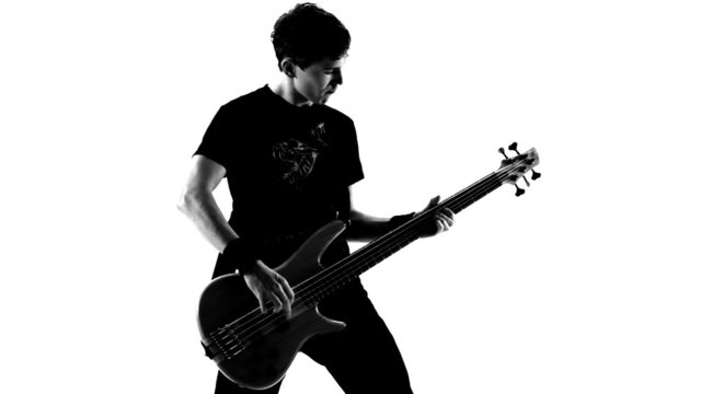 Playing guitar in a studio. Black and white video.