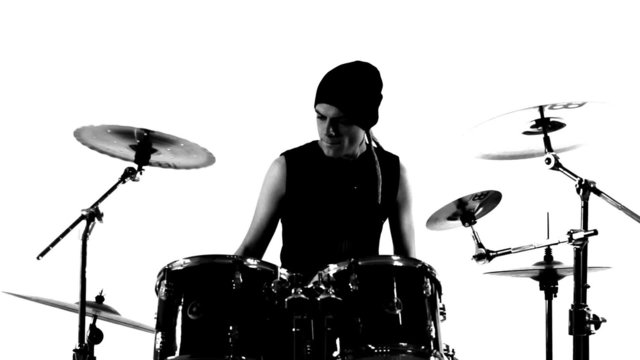 Drummer in a studio. Black and white video.