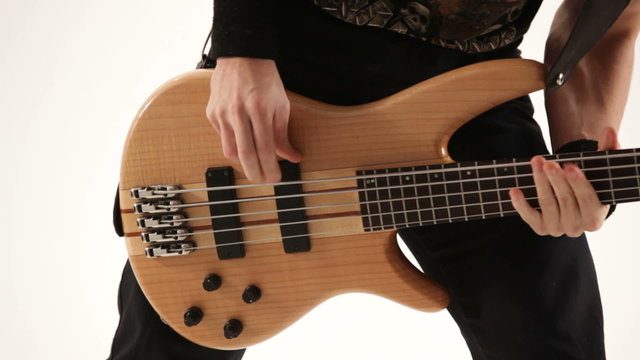 Guy playing guitar in a studio. Close-up.