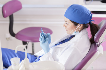 Dentist relaxing and listening to music at the dental office